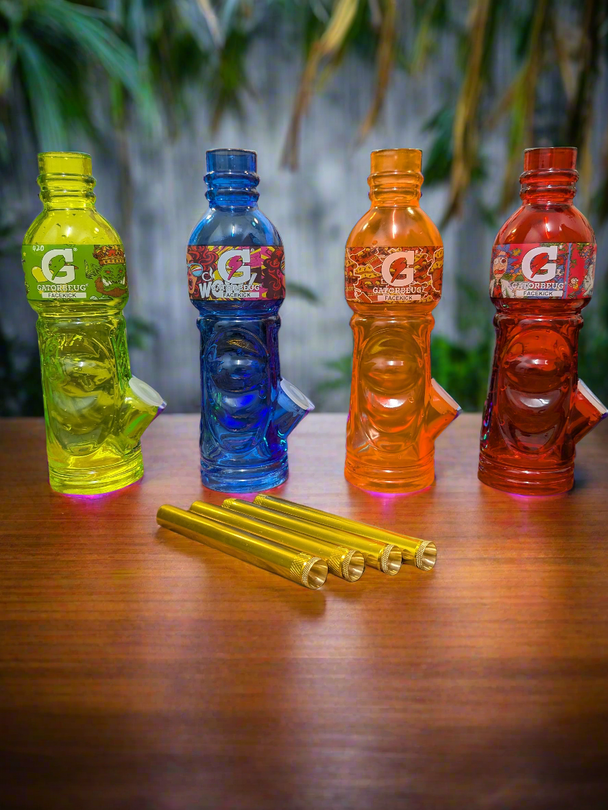 “Gatorbeug Facekick waterpipes in Gatorade-style bottles – vibrant yellow, blue, orange, and red acrylic bongs with gold cone pieces, displayed on wooden table with tropical background.”